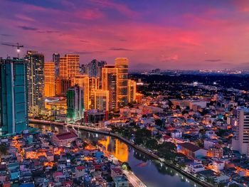 High angle view of illuminated buildings against sky during sunset
