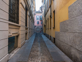 Empty alley amidst buildings in city