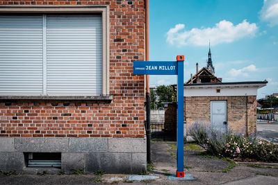 Road sign against building