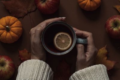 Directly above shot of hand holding coffee cup