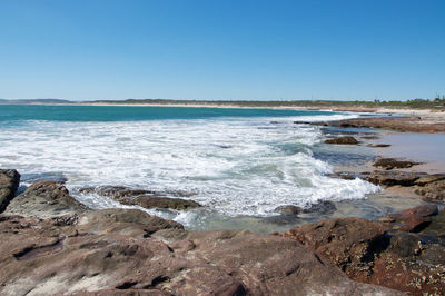 Scenic view of beach against clear sky