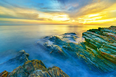 Scenic view of sea against sky at sunset