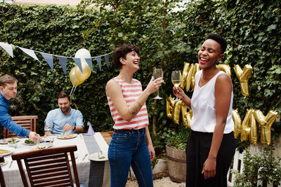 Portrait of smiling friends enjoying picnic