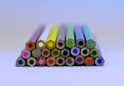 Close-up of multi colored pencils over white background