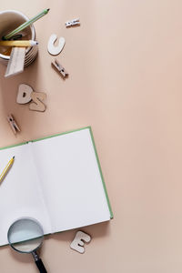 Directly above shot of pen and book on table