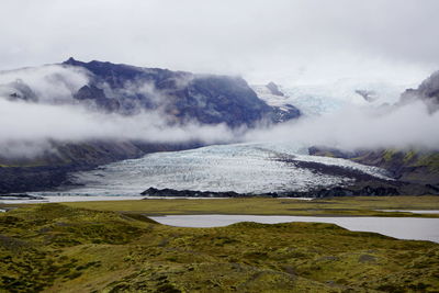 Scenic view of lake and mountains against sky