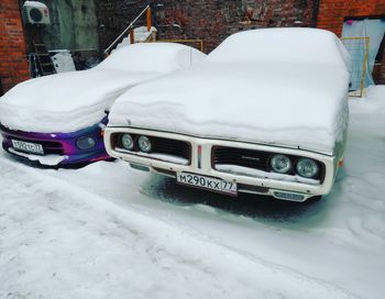 Snow covered car on street during winter