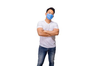 Full length portrait of young man standing against white background