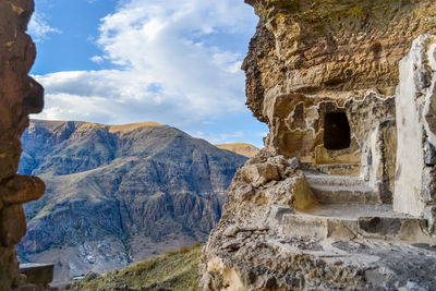 View of rock formation against cloudy sky