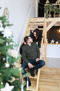 A happy couple in love are preparing for the christmas holiday in the decorated kitchen of the house