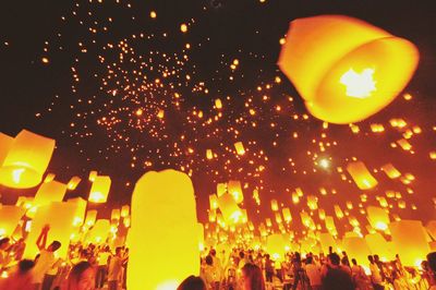 Low angle view of illuminated lights at night