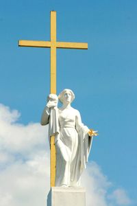 Low angle view of statue against blue sky