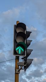 Low angle view of road sign against sky