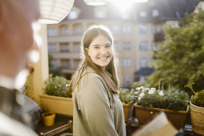 Portrait of smiling young woman standing in market