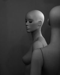 Close-up of mannequins against dark background