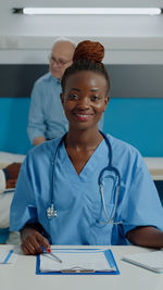 Portrait of female doctor working in office