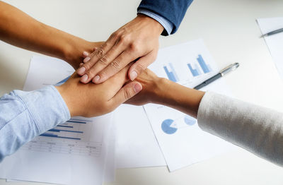 Cropped image of business people at desk in office