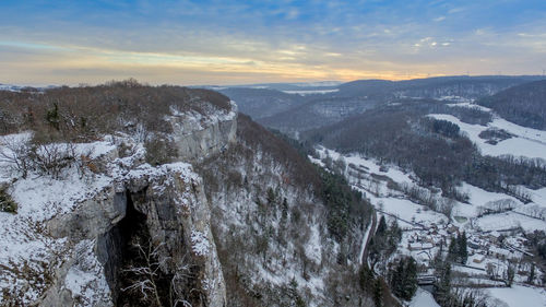 Scenic view of snow covered mountains against sky during sunset