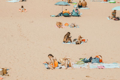 High angle view of people sitting on beach