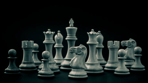 Close-up of chess pieces against black background