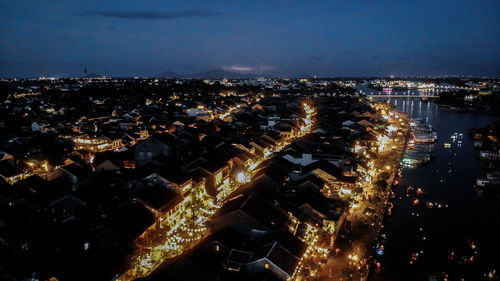 High angle view of illuminated buildings in city at night