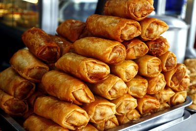 Photo of a stack of deep fried vegetable spring roll.