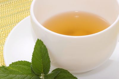 High angle view of herbal tea in cup on table
