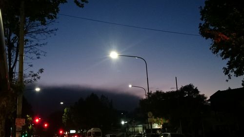 Illuminated city against sky at night