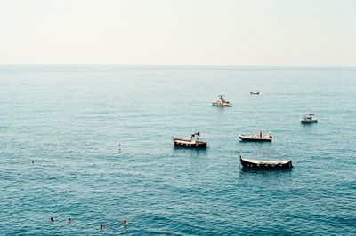 Boats in sea against sky