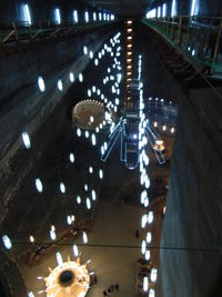 High angle view of illuminated lights in city at night