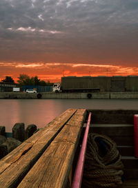 Pier over sea against sky during sunset