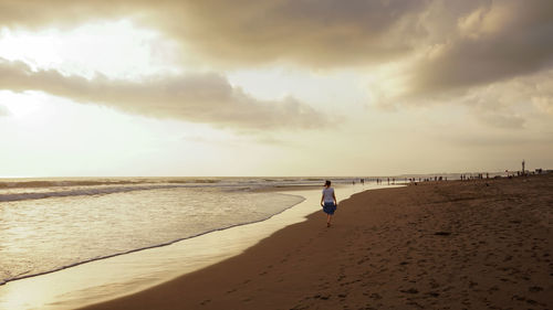 Full length of man on beach against sky