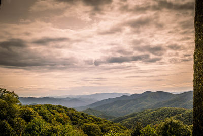 Scenic view of mountains against cloudy sky