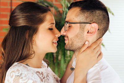Close-up of couple embracing indoors