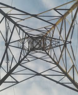 Low angle view of electricity pylon against sky