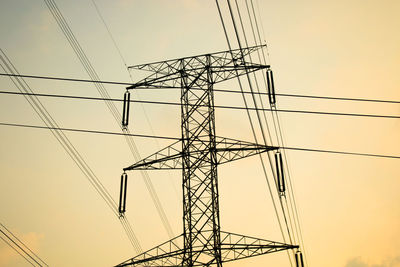 Low angle view of electricity pylon against sky