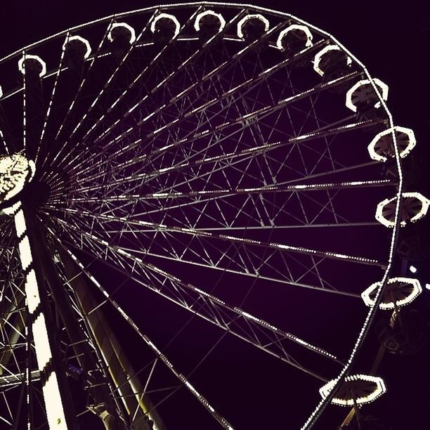 arts culture and entertainment, ferris wheel, amusement park ride, amusement park, night, low angle view, metal, illuminated, spinning, clear sky, sky, circle, outdoors, no people, metallic, pattern, big wheel, motion, large, fun