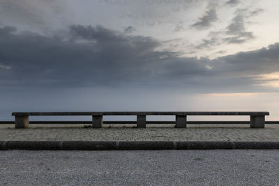 Surface level of pier over sea against sky