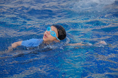 Portrait of boy swimming in pool