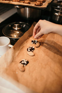 Midsection of person having cookies