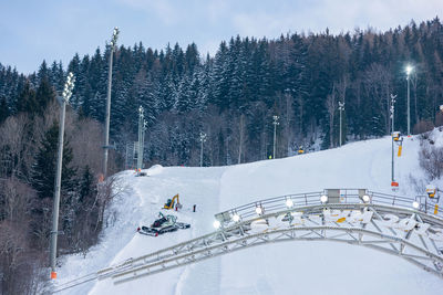 View of people skiing on snow covered land