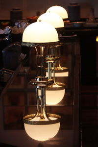 Close-up of illuminated lamp on table at home