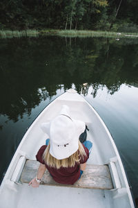 High angle view of boy sitting on boat