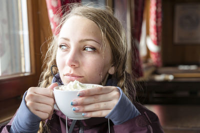 Young woman having hot chocolate