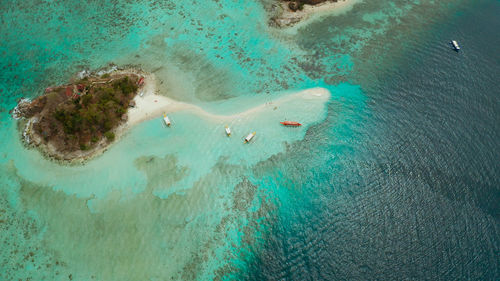 Seascape tropical island and sand beach, turquoise water and coral reef.malacory island, philippines