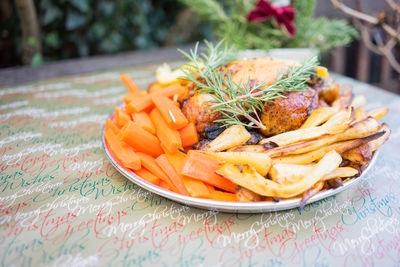 Christmas dinner on a plate outside on a table in a back garden 