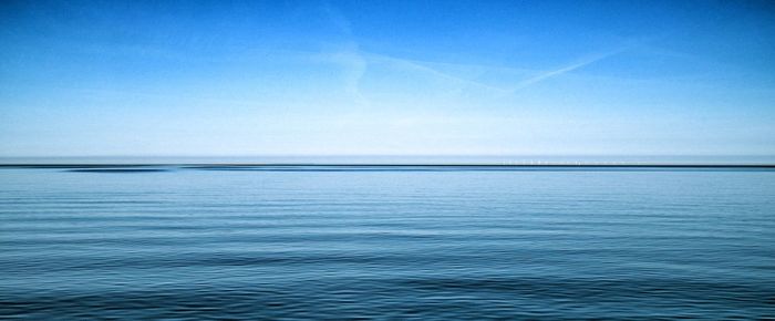 Scenic view of sea against clear blue sky