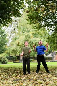 Full length of a smiling women standing in park