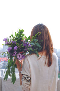 Portrait of a young woman holding white flowers