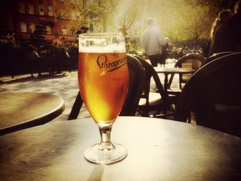 Close-up of beer glass on table at cafe